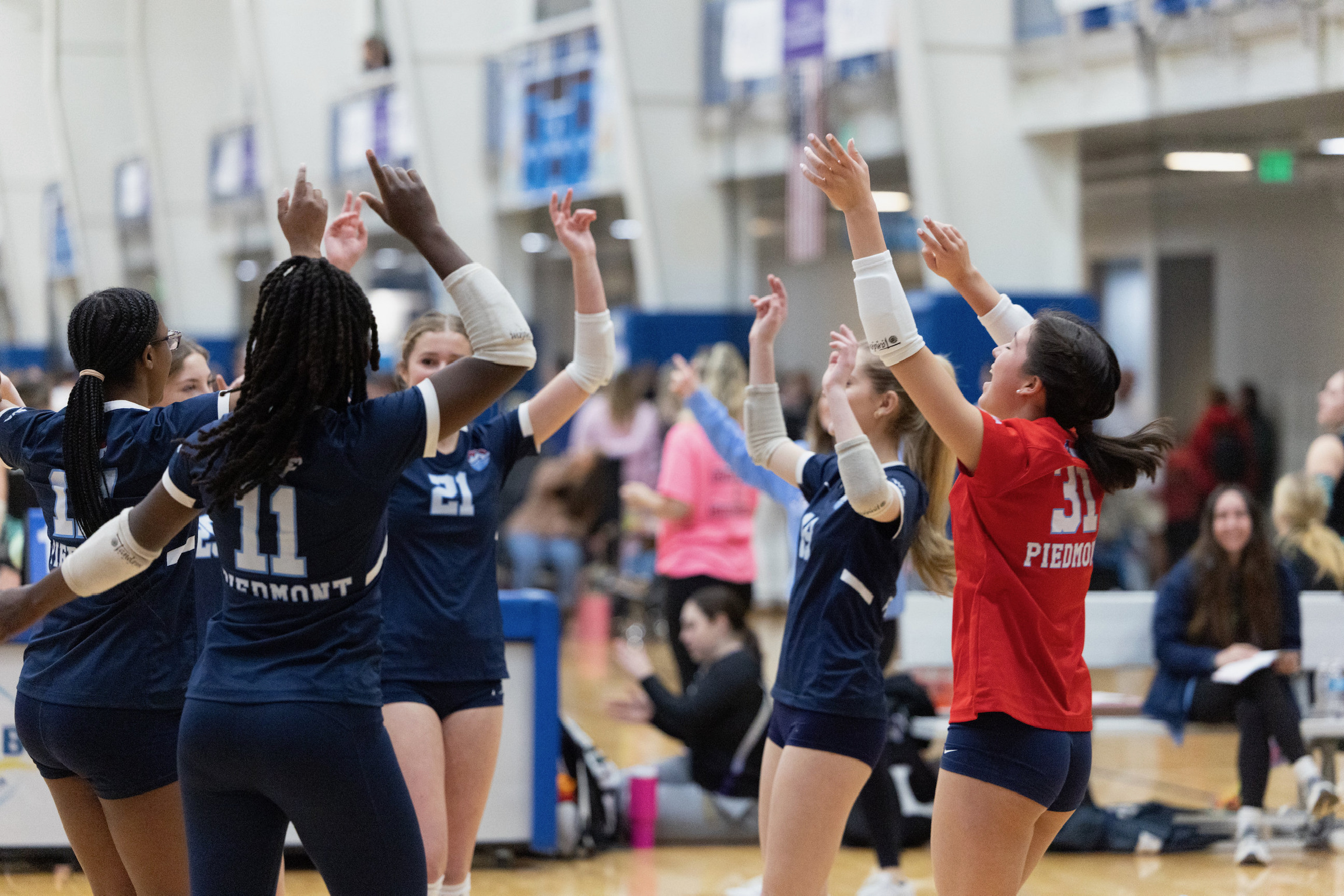 PVC 15 JDI athletes celebrating with arms raised